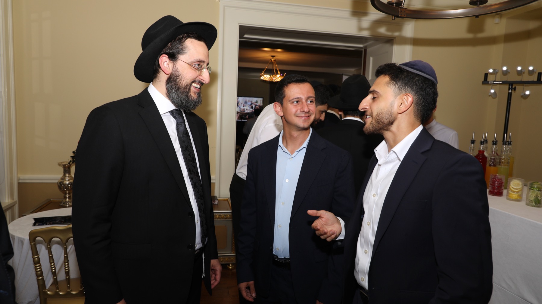 Community members sharing conversation at a Torah Shelaima evening