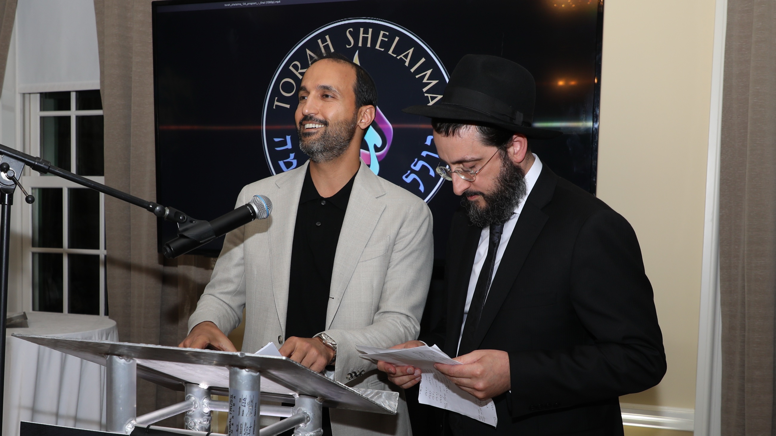 Torah Shelaima leadership sharing the vision at a community event